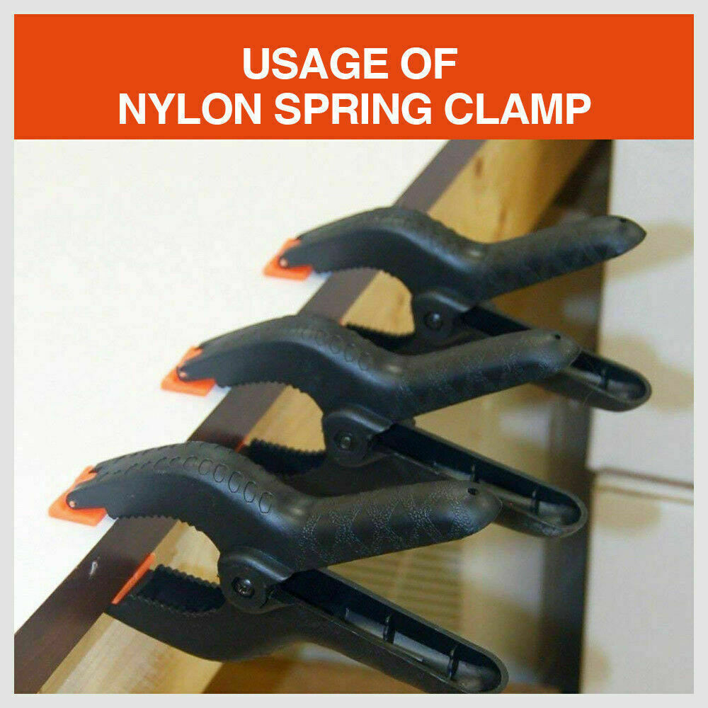 Four-piece set of 9-inch black heavy-duty nylon spring clamps, showcasing their strong, quick grip design and large size, suitable for a variety of clamping tasks