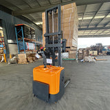 Stand-up electric stacker with 3-meter lift height and 1500kg capacity. Designed for efficient material handling in warehouses, featuring durable construction, ergonomic controls, and compact design for easy maneuverability.