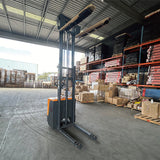 Stand-up electric stacker with 3-meter lift height and 1500kg capacity. Designed for efficient material handling in warehouses, featuring durable construction, ergonomic controls, and compact design for easy maneuverability.