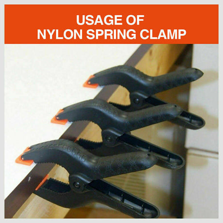 Four-piece set of 9-inch black heavy-duty nylon spring clamps, showcasing their strong, quick grip design and large size, suitable for a variety of clamping tasks